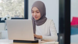 Utama beautiful asia muslim lady casual wear working using laptop in m